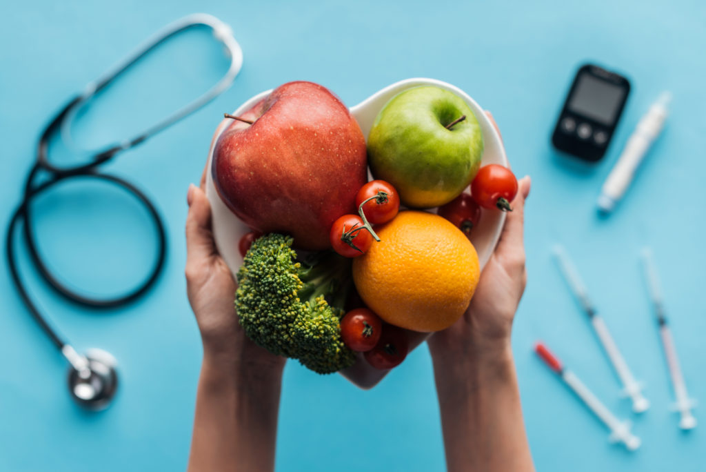 A person holding a variety of fresh, colorful fruits in their hand, showcasing a healthy and nutritious food choice.