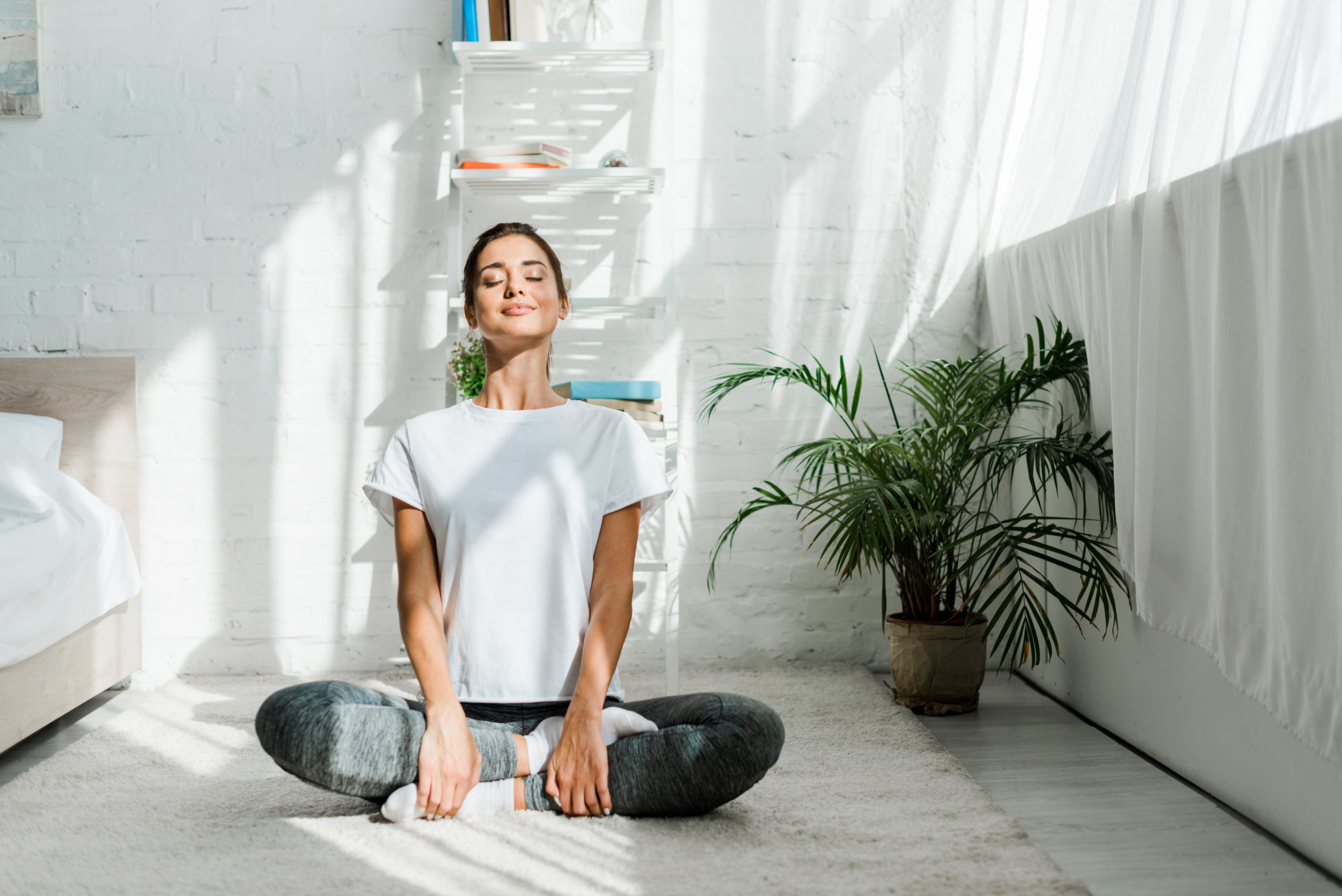A woman in a state of relaxation, practicing deep breathing techniques for stress relief and relaxation.