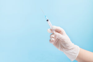 hand with syringe. making injection with copy space. hand holdin