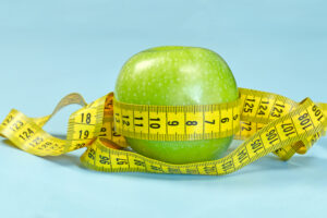 Apple surrounded by tape measure